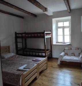 a bedroom with two bunk beds and a window at Mzia's Garden in Kʼvakhvreli