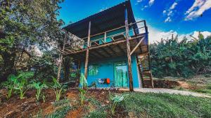 a blue house with a balcony on top of it at Flat Noronha Dreams in Fernando de Noronha