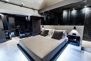 a bedroom with a large bed and a piano at 4 Suites " unconventional living rooms " in Catania
