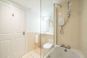 a bathroom with a shower and a toilet at Quayside Apartment in Dundee +23 photos