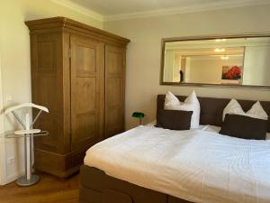 a bedroom with a large bed and a large mirror at Jagdschloss Suite - premium castle hideway in Hohen Niendorf