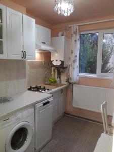 a kitchen with a washing machine and a window at Cozy, central 1-bedroom apartment in Timisoara, Romania in Timişoara