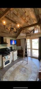 a kitchen with a ladder in the middle of a room at Lake View Lodges in Long Melford