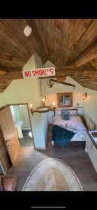 a bedroom with a no smoking sign on a ceiling at Lake View Lodges in Long Melford