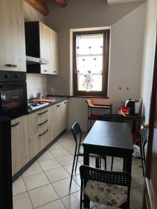 kuchnia ze stołem i krzesłami oraz oknem w obiekcie Casa vacanze fra gli ulivi w mieście Morano Madonnuccia