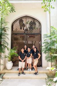 a group of people standing in front of a door at Casa Wahh in Tulum