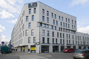 a white building with a sign on the side of it at Modern Studio Targowa 10 AC in Warsaw