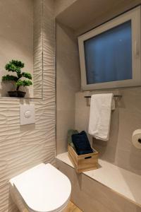 a bathroom with a toilet and a flat screen tv at Nono's House I in Dubrovnik +17 photos