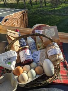a basket of eggs and other food on a table at Willowbarn Rafford Self Catering in Forres