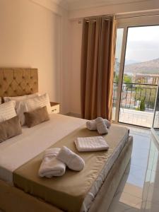 a bedroom with a bed with two towels on it at Golden Hill Ksamil in Ksamil