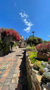 a garden with flowers and plants on a stone path at Home Mark Casa Boutique in Paipa