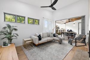 a living room with a couch and a table at Papillon Coolum in Coolum Beach
