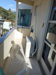 a television sitting on the balcony of a house at LUZ DO LUAR in Pedra Azul