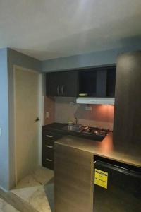 a kitchen with a sink and a stove top oven at R.1109 Estudio ejecutivo. in Panama City +4 photos