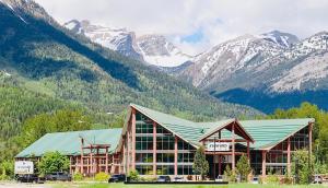 a large building with mountains in the background at Fernie Stanford Resort in Fernie