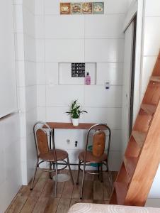 a small table and two chairs in a room at Trip Adventure Poa in Porto Alegre
