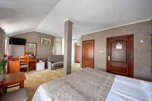 a hotel room with a bed and a desk at Hotel Przepióreczka in Nałęczów