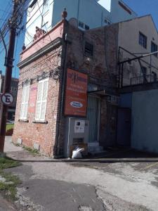 a brick building with a sign on the side of it at Trip Adventure Poa in Porto Alegre