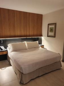 A bed or beds in a room at Lastarria Hotel