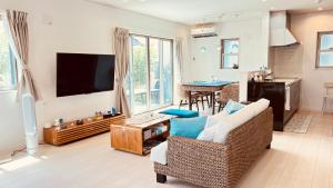 a living room with a couch and a tv at Blue Ocean in Inbu +35 photos