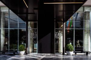 a building with two potted plants in front of it at SLS Buenos Aires Puerto Madero in Buenos Aires