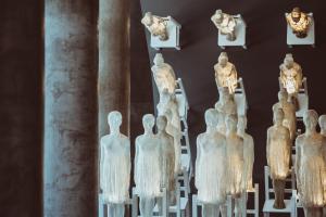 a group of statues on display in a museum at SLS Buenos Aires Puerto Madero in Buenos Aires