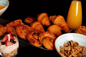a table topped with pastries and a plate of nuts at SLS Buenos Aires Puerto Madero in Buenos Aires