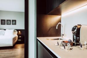 a kitchen counter with a sink and glasses on it at SLS Buenos Aires Puerto Madero in Buenos Aires