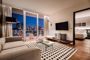 a living room with a view of a city at SLS Buenos Aires Puerto Madero in Buenos Aires