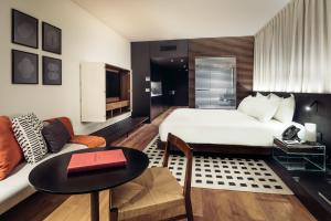a hotel room with a bed and a couch at SLS Buenos Aires Puerto Madero in Buenos Aires