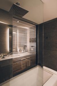 a bathroom with a glass shower and a sink at SLS Buenos Aires Puerto Madero in Buenos Aires
