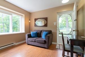 a living room with a couch and a mirror at Westover Inn in Saint Marys