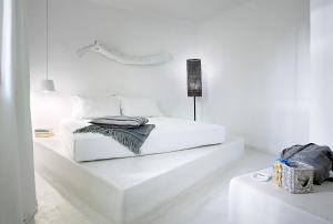 a white bedroom with a white bed in a room at Artemis Seaside Resort in Paliochori