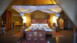 a bedroom with a bed in a tent at Severin Safari Camp in Tsavo West National Park