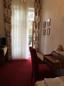 a hotel room with a desk and a window at Hotel Galleria in Munich