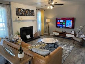 a living room with a couch and a tv at Sunrise Experience w/King Size Bed & Pet Friendly in Roswell