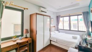 Postel nebo postele na pokoji v ubytování VNAHOMES Serviced Apartment