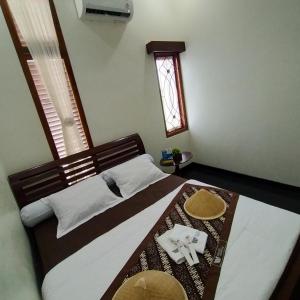 Ένα ή περισσότερα κρεβάτια σε δωμάτιο στο Walasa Ayu Homes By MSH