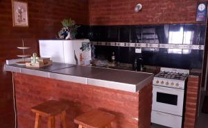 a kitchen with a counter top and a stove at Departamentos Ensueños in Trelew