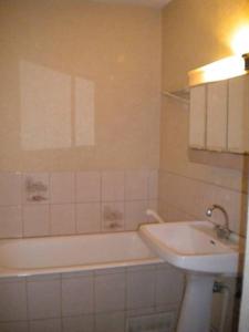 a bathroom with a sink and a bath tub and a sink at Mercier in Lanslevillard