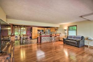 a living room with a couch and a kitchen at Spacious Frazee Home with Direct Lake Access! in Frazee