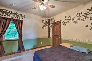 a bedroom with a bed and a ceiling fan at Spacious Frazee Home with Direct Lake Access! in Frazee