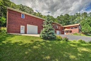 a brick house with a garage in a yard at Spacious Frazee Home with Direct Lake Access! in Frazee