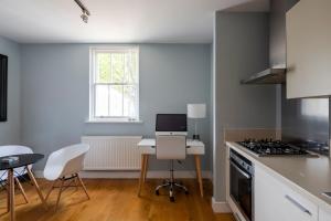 a kitchen with a desk with a computer on it at Luxurious Private One Bedroom Apartment in Braintree with Free Parking Near City Centre in Braintree +20 photos