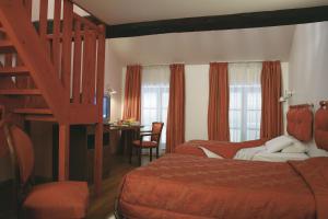 a hotel room with two beds and a staircase at Le Saint Michel in Sedan