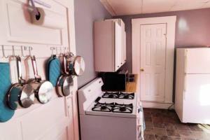 a kitchen with a white stove and a white refrigerator at Private Studio- Queen Bed- 10 min to DT Indy in Indianapolis +9 photos