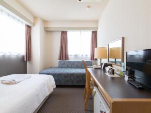 Postel nebo postele na pokoji v ubytování Nagasaki Orion Hotel
