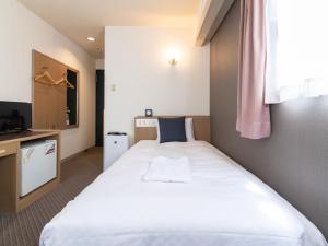 Postel nebo postele na pokoji v ubytování Nagasaki Orion Hotel