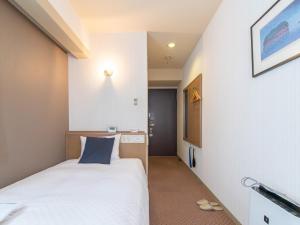 Postel nebo postele na pokoji v ubytování Nagasaki Orion Hotel