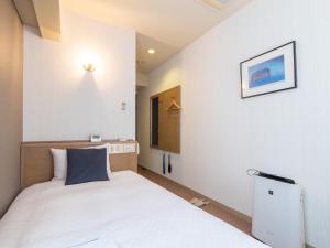 Postel nebo postele na pokoji v ubytování Nagasaki Orion Hotel